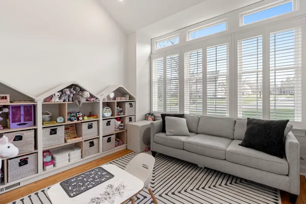 a living room with furniture and a floor to ceiling window
