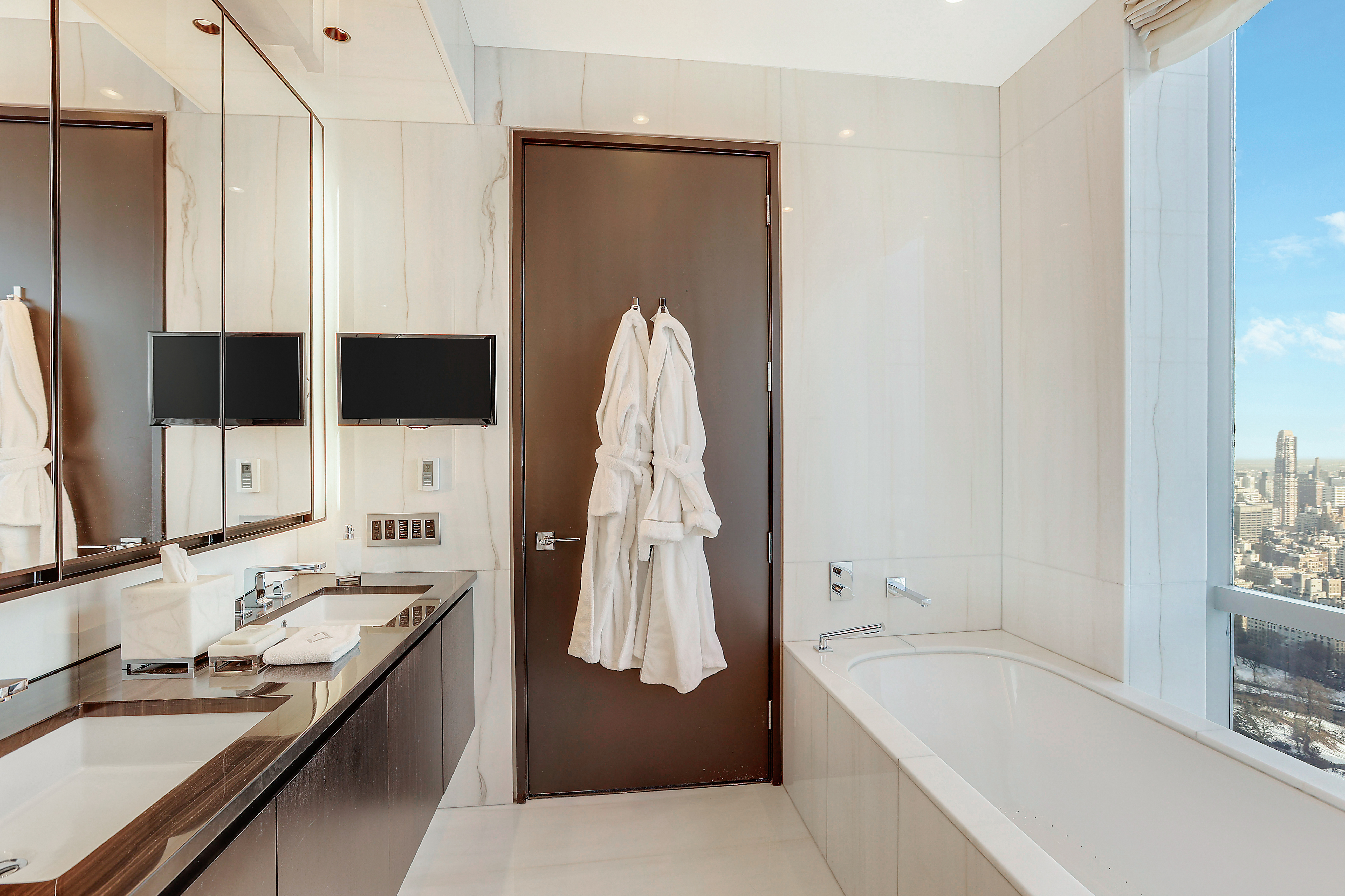 157 West 57th Street, Unit 51A Manhattan, NY 10019 - Photo 12 of 15 a bathroom with a tub sink and mirror