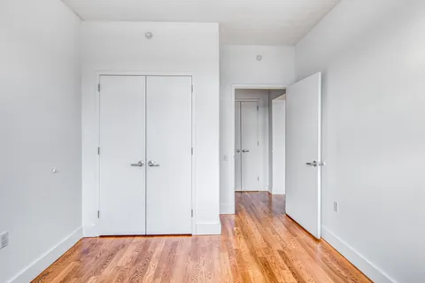 a view of a room with wooden floor