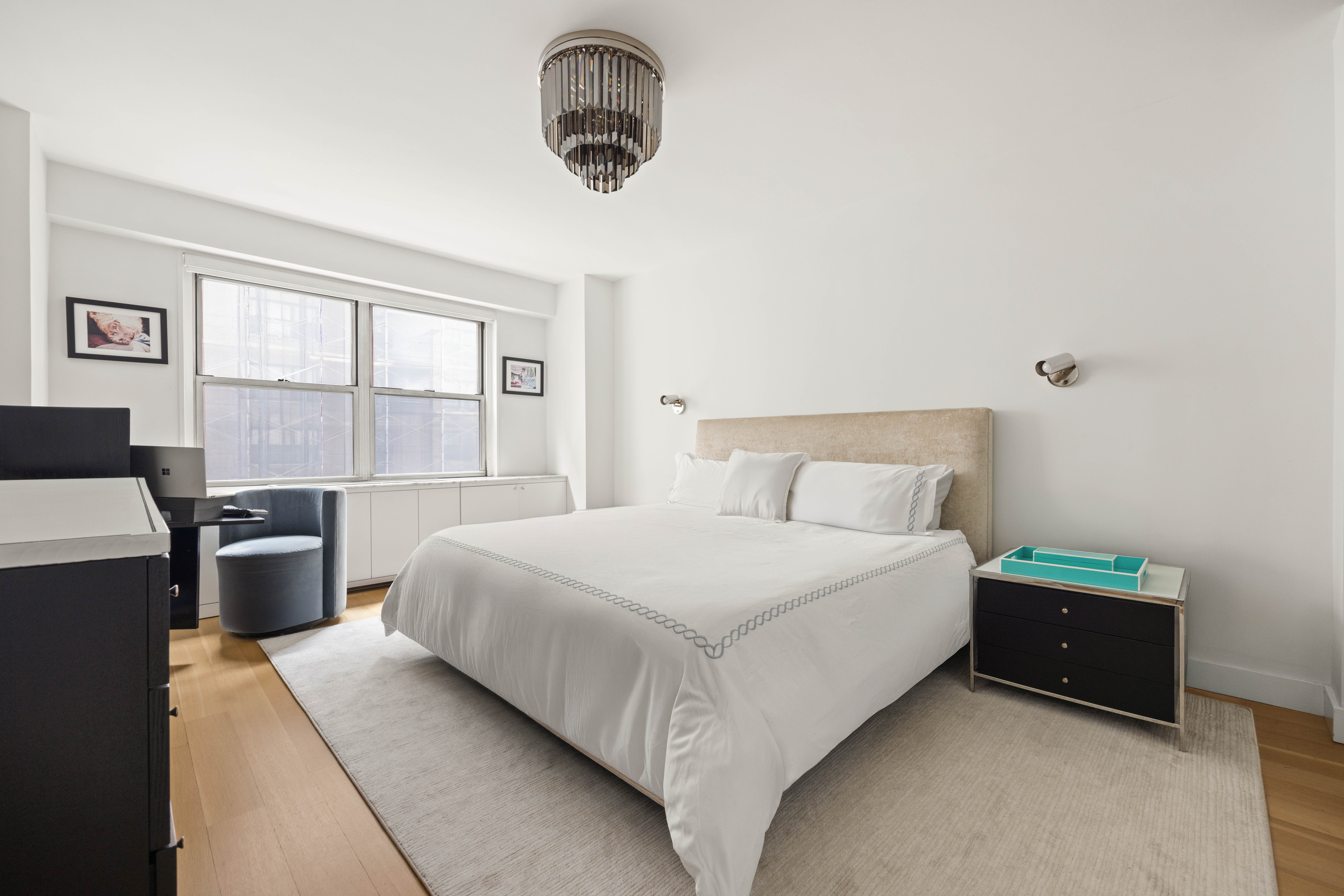 136 East 56th Street, Unit 4EF Manhattan, NY 10022 - Photo 5 of 10 a bedroom with bed and window