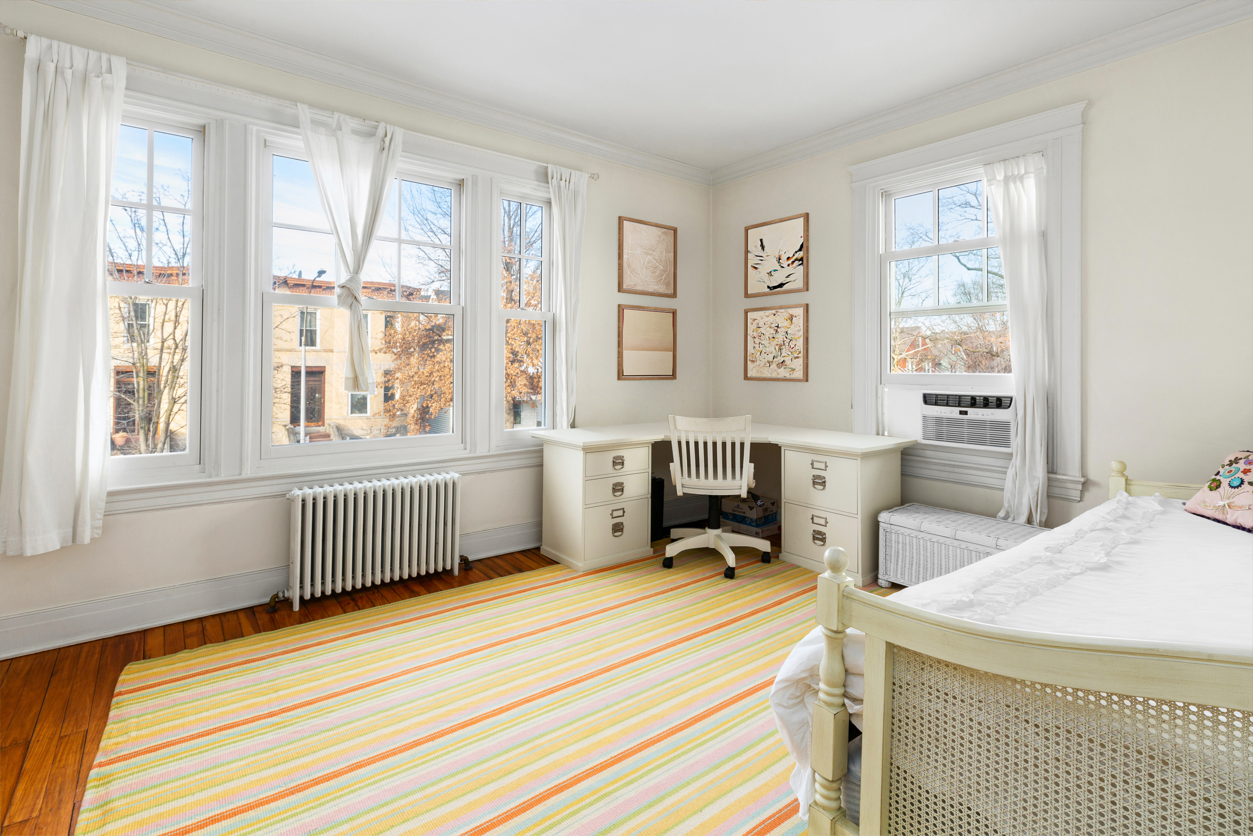 200 Fenimore Street Brooklyn, NY 11225 - Photo 14 of 24 a bedroom with a bed a table and three windows