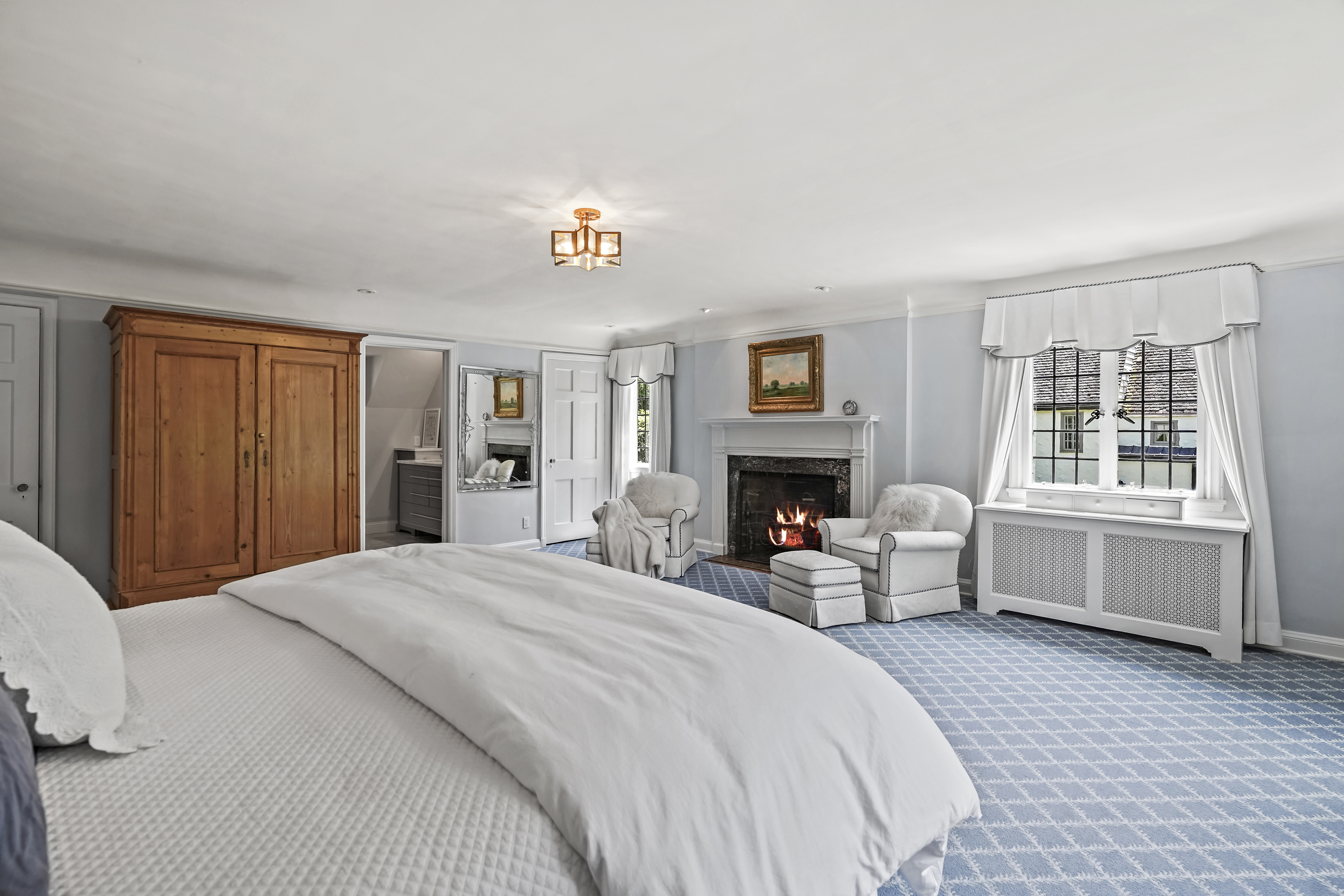 19 Avon Road Larchmont, NY 10538 - Photo 12 of 35 a spacious bedroom with a bed and a couch