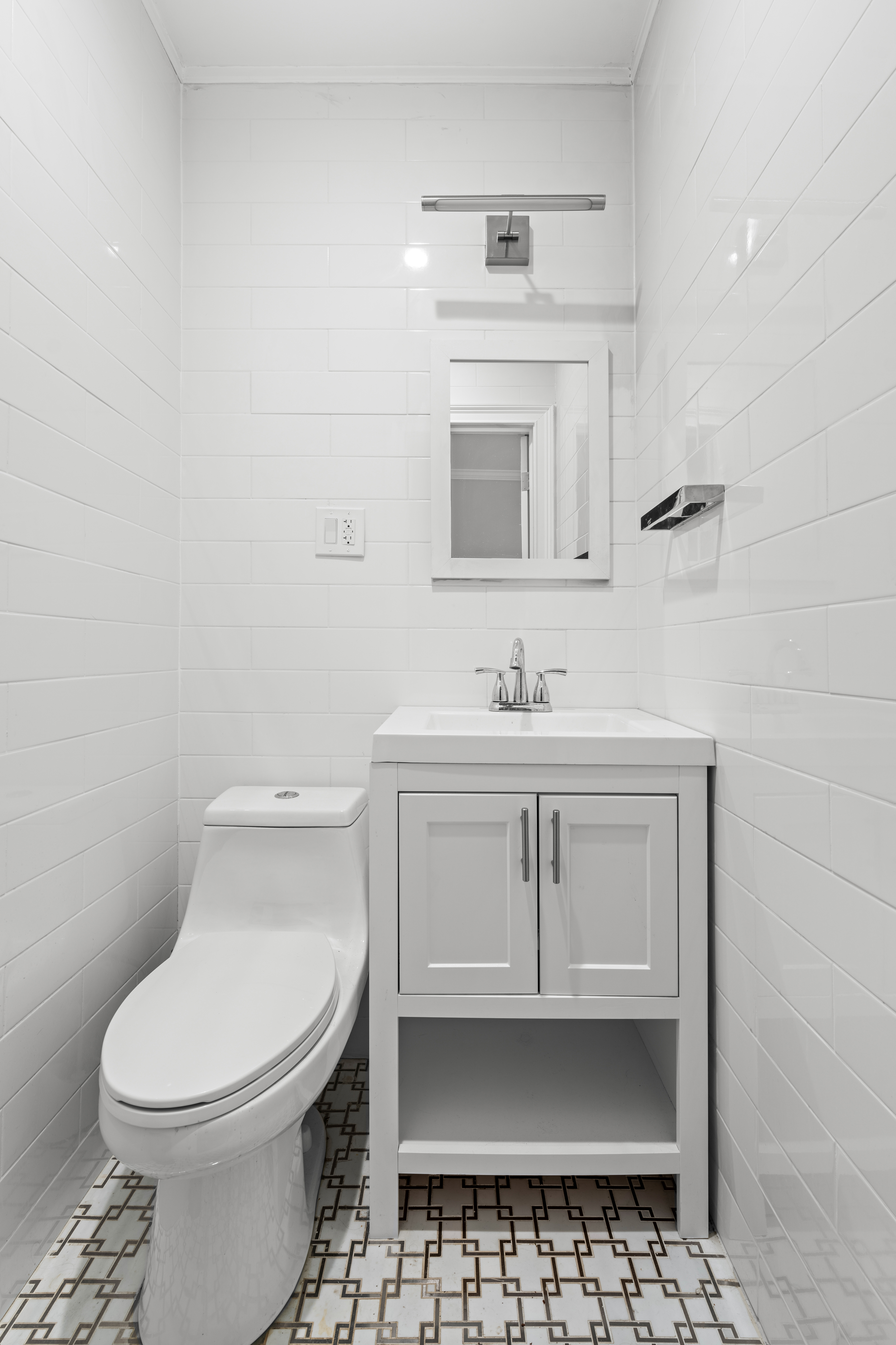 181 Park Avenue Brooklyn, NY 11205 - Photo 12 of 19 a bathroom with a sink toilet and mirror