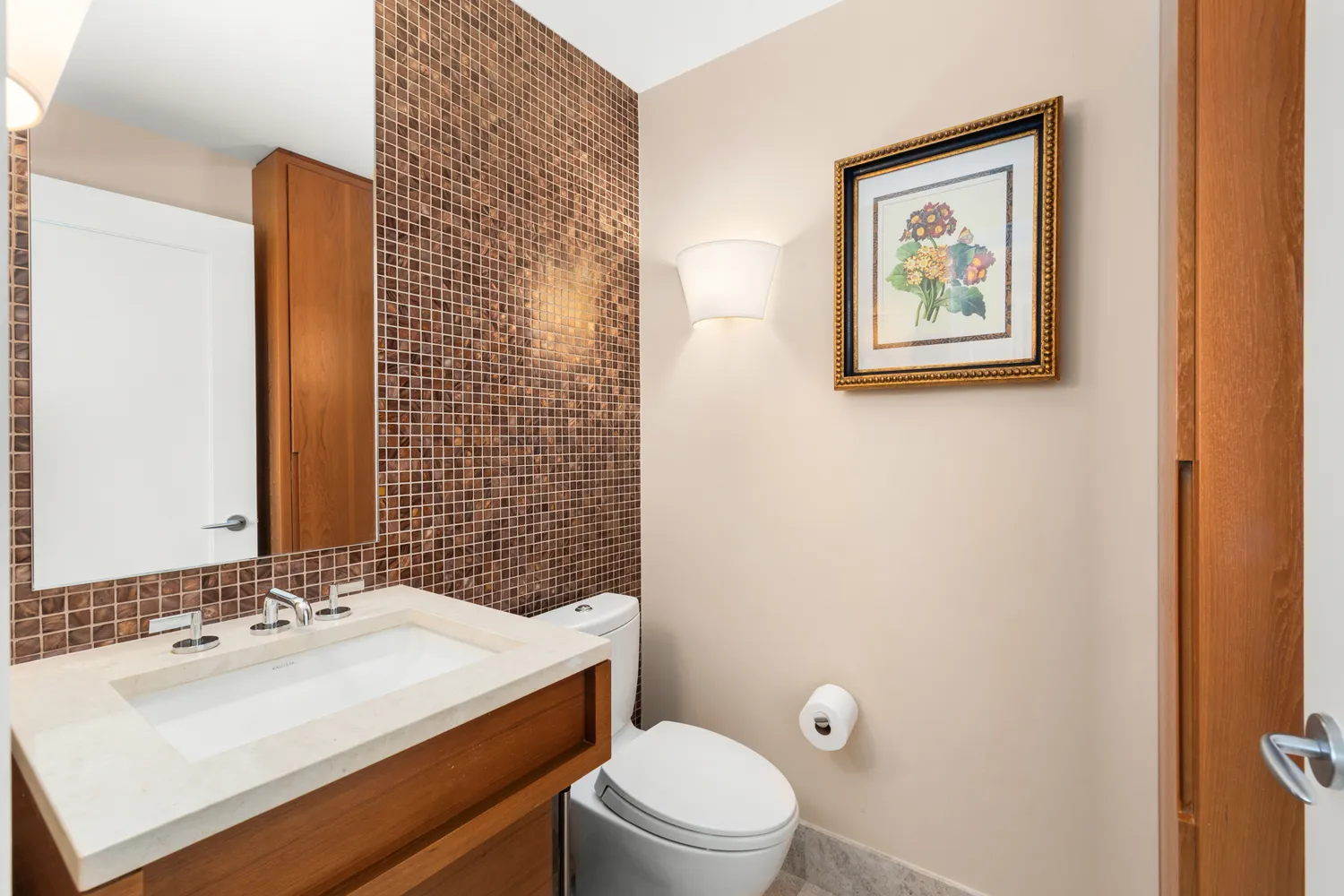 a bathroom with a sink toilet and mirror