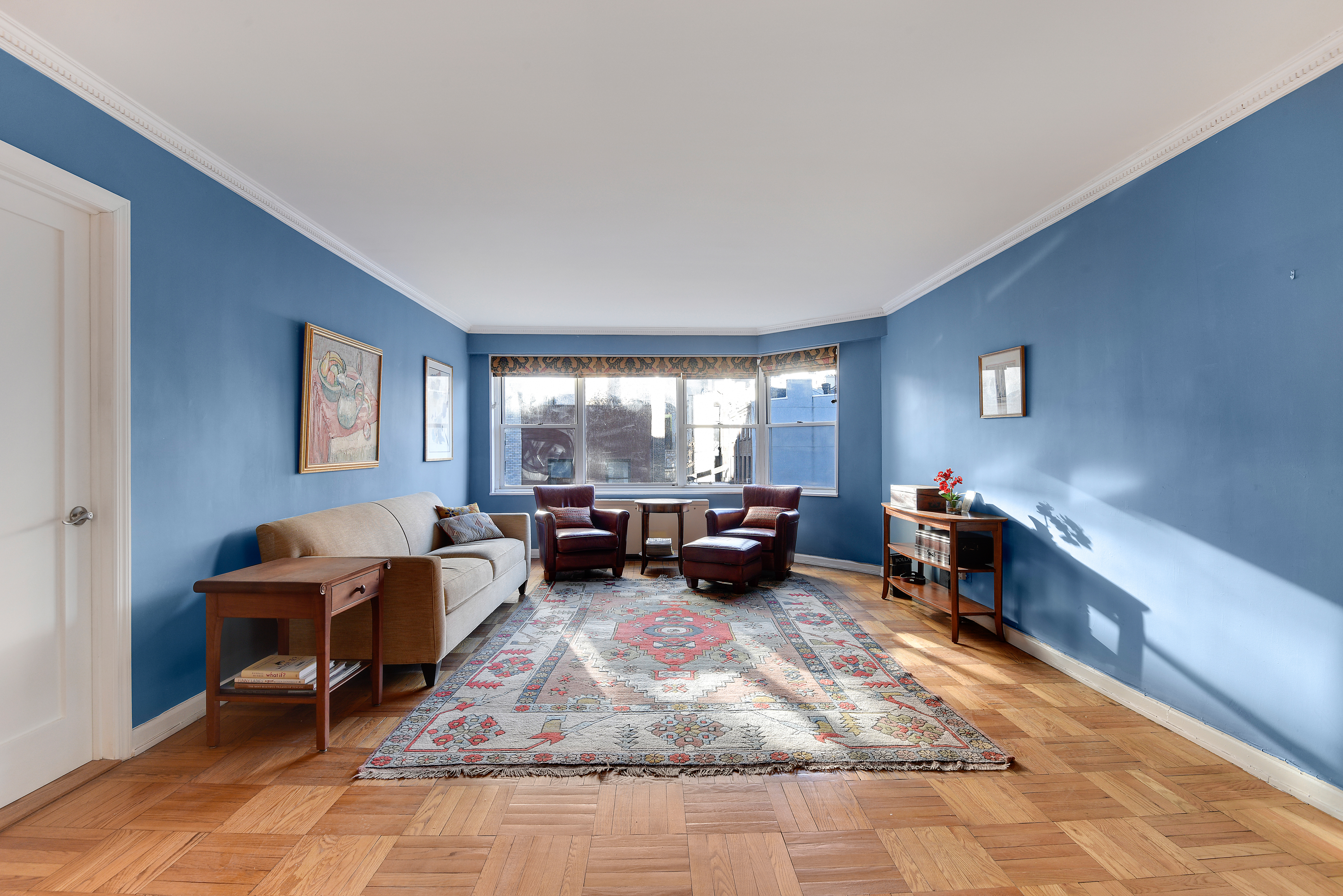 150 East 61st Street, Unit 5C Manhattan, NY 10065 - Photo 4 of 18 a living room with furniture and a table