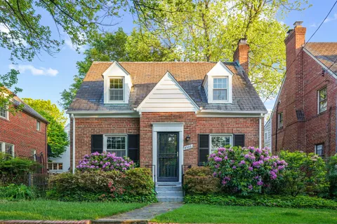 a front view of house with a garden