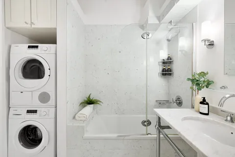 a bathroom with a sink a washer and dryer
