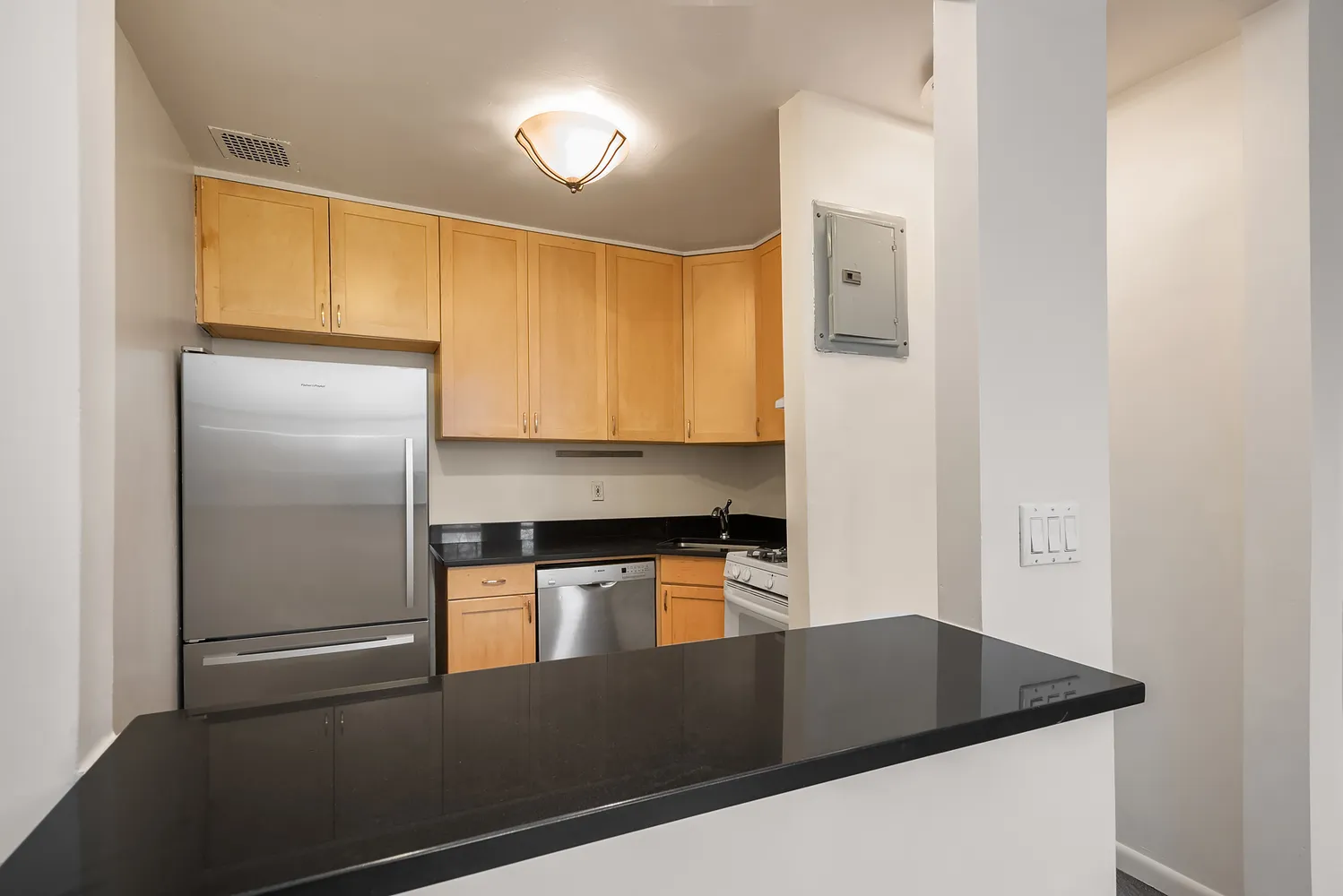 a kitchen with a refrigerator and a stove