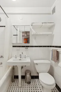 a white toilet sitting next to a bathroom sink