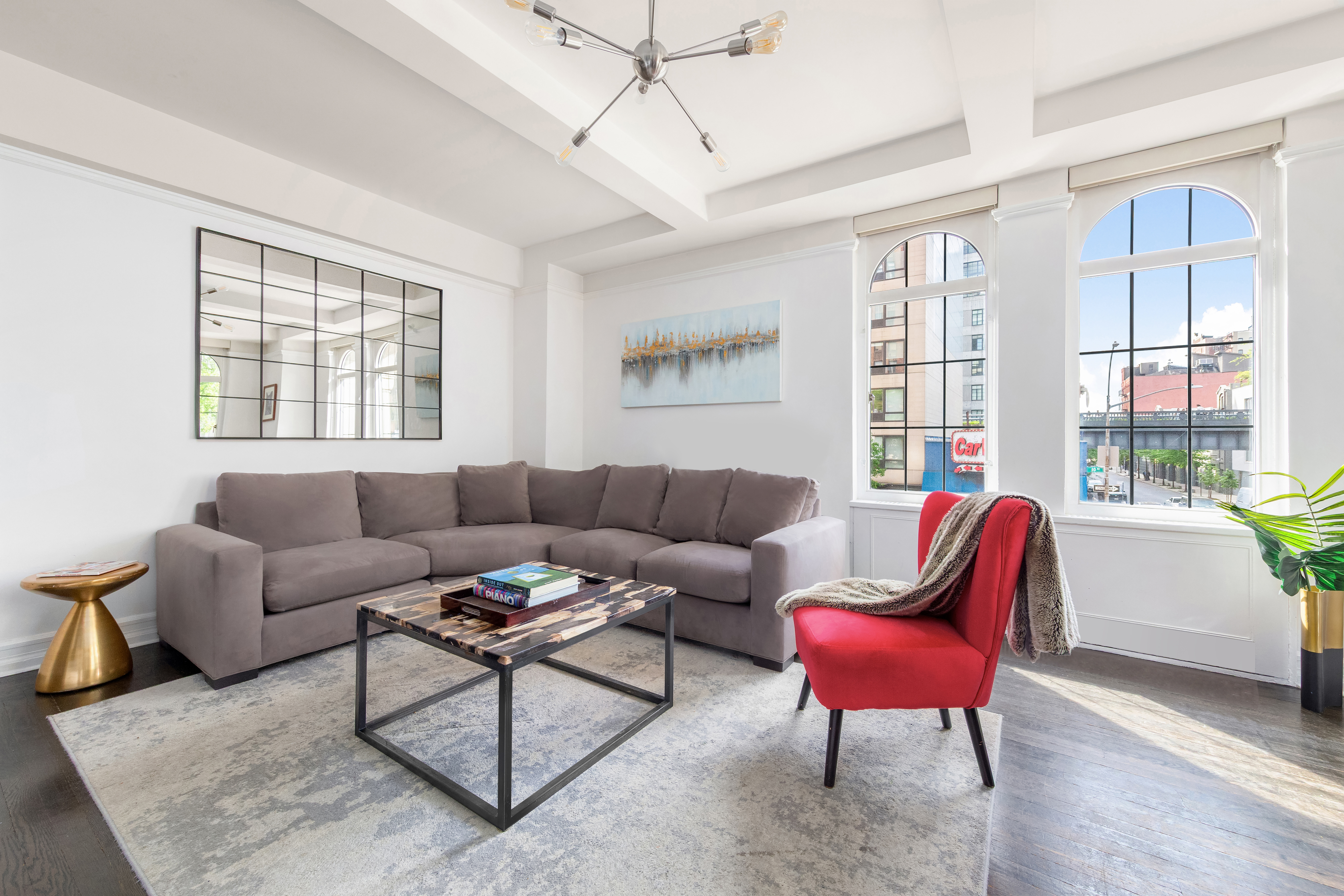 470 West 24th Street, Unit 2C Manhattan, NY 10011 - Photo 2 of 15 a living room with furniture a large window and a wooden floor