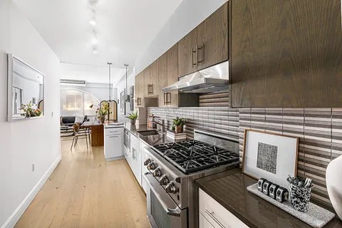 a kitchen with a stove a sink and a refrigerator