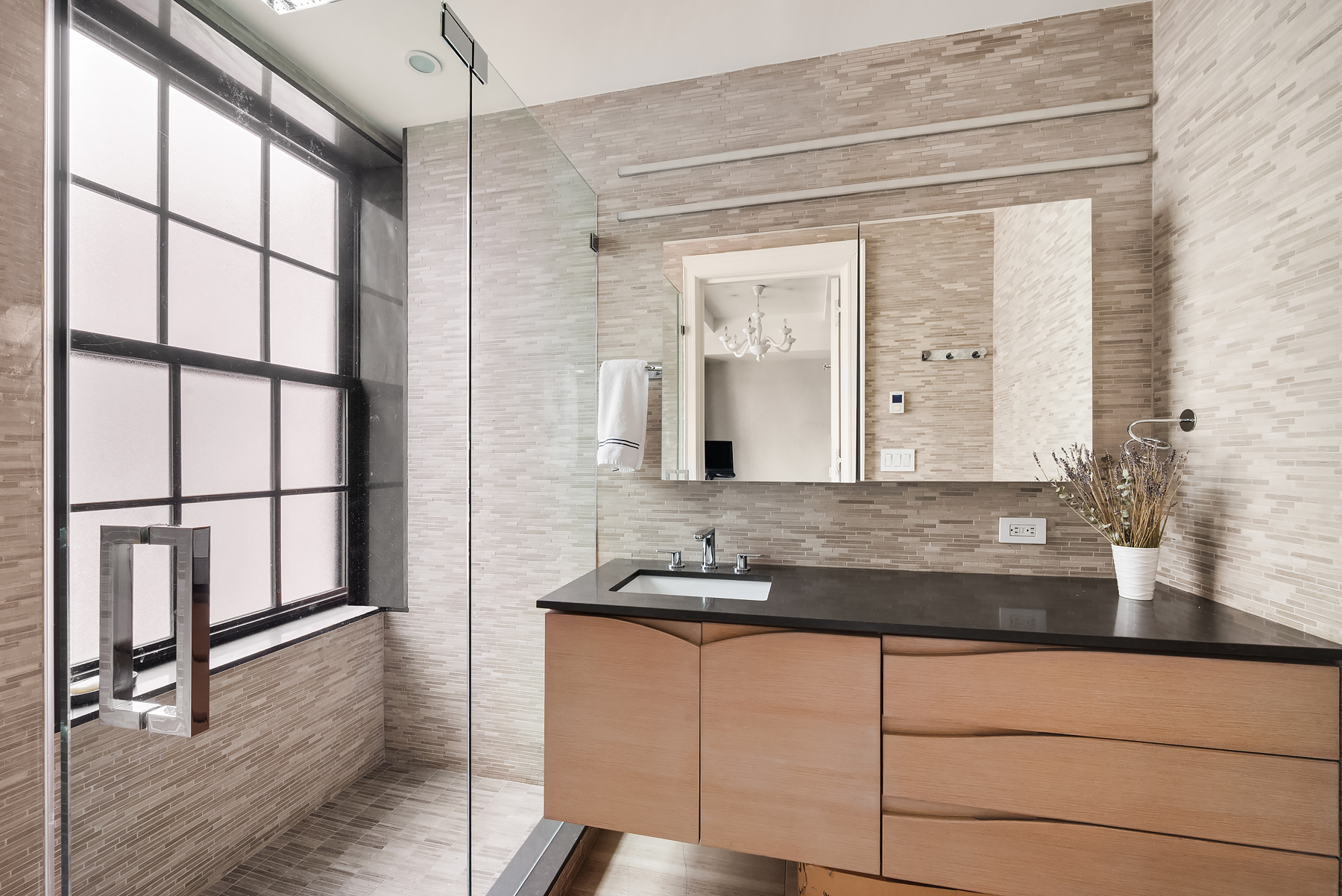 77 Park Avenue, Unit 11E Manhattan, NY 10016 - Photo 6 of 10 a bathroom with a granite countertop sink and a mirror