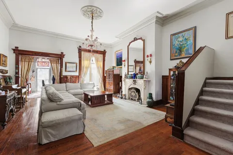 a living room with furniture or couch and a chandelier