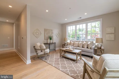 a living room with furniture and large windows