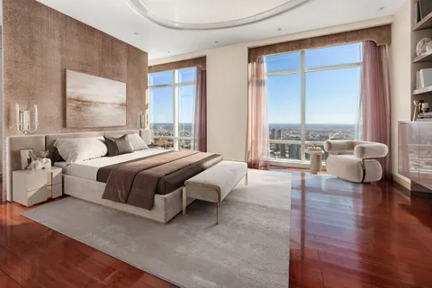 a bedroom with a large bed and a large window