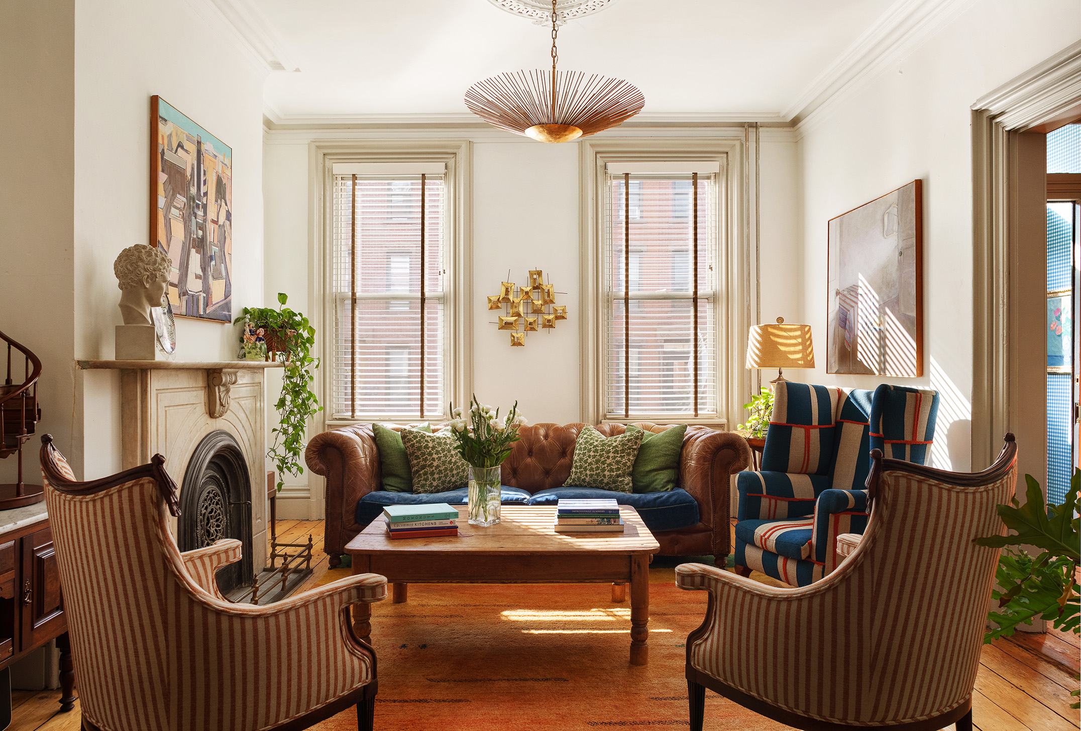 a living room with furniture a chandelier and a window