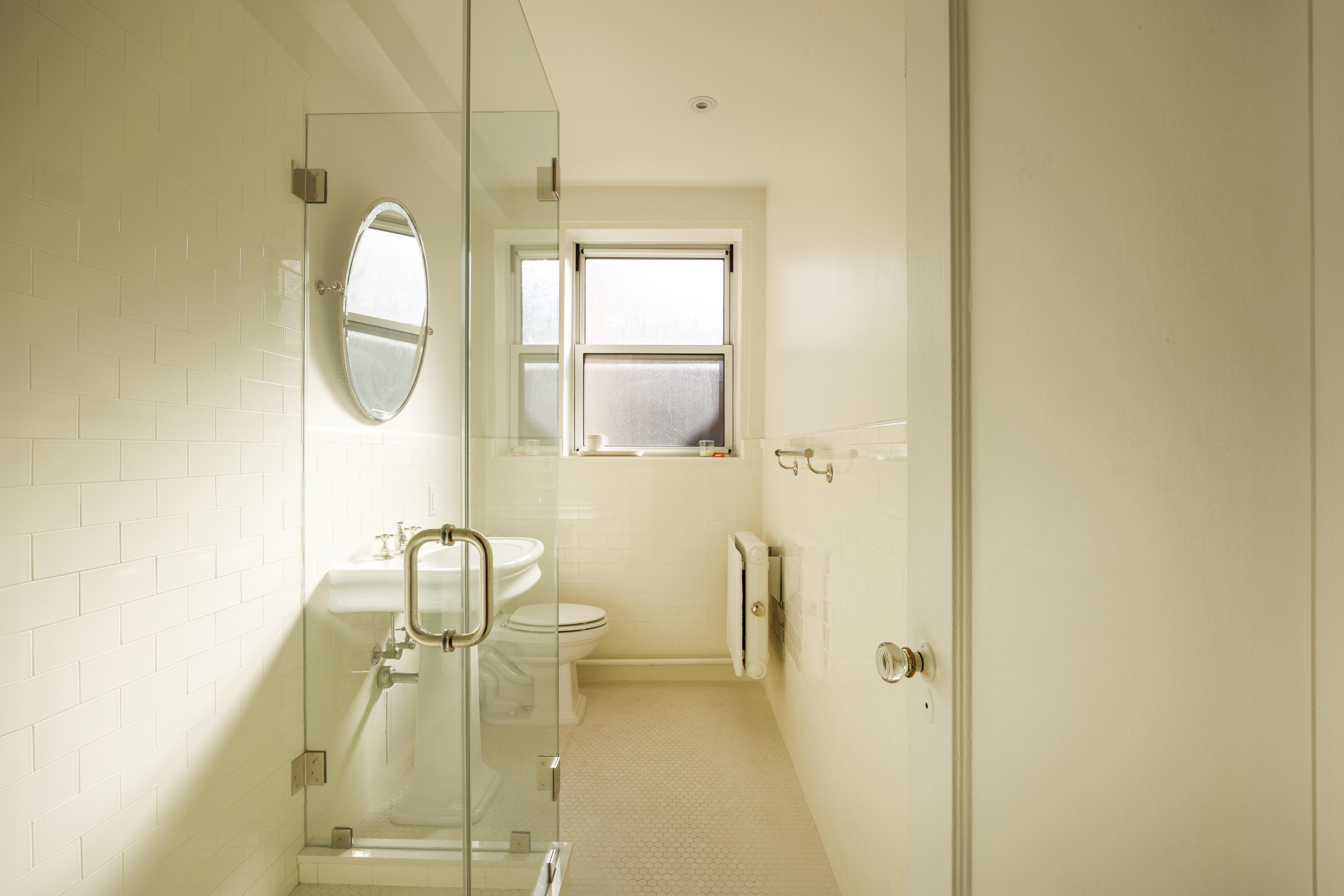 131 Avenue B, Unit 5C Manhattan, NY 10009 - Photo 15 of 18 a bathroom with a sink and a mirror