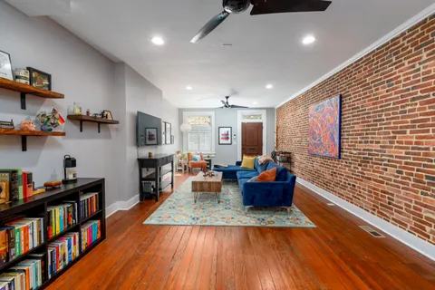 a living room with furniture and a book shelf