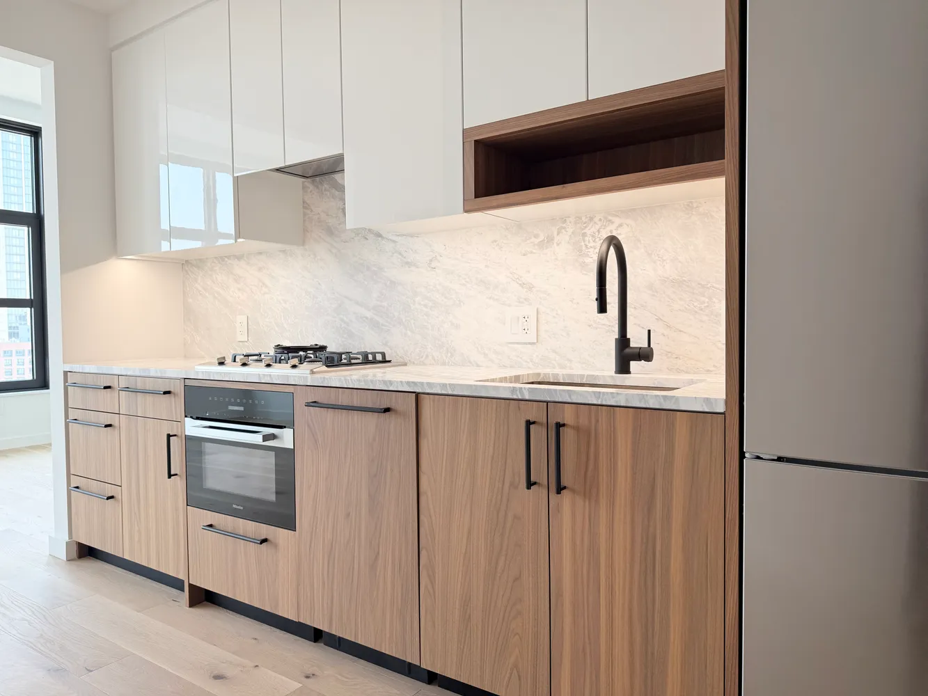 a kitchen with white cabinets and white appliances
