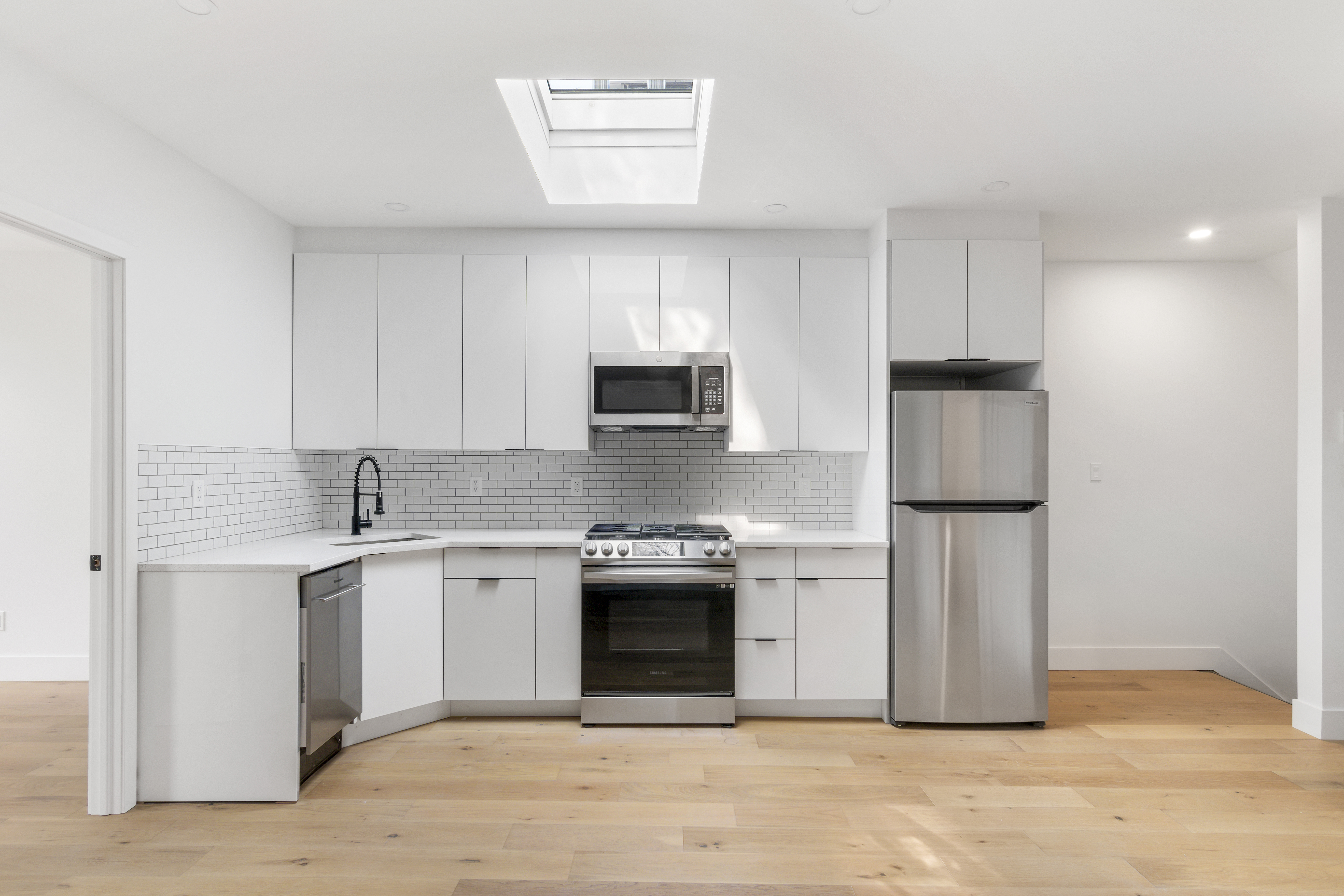 a kitchen with a sink stainless steel appliances and cabinets