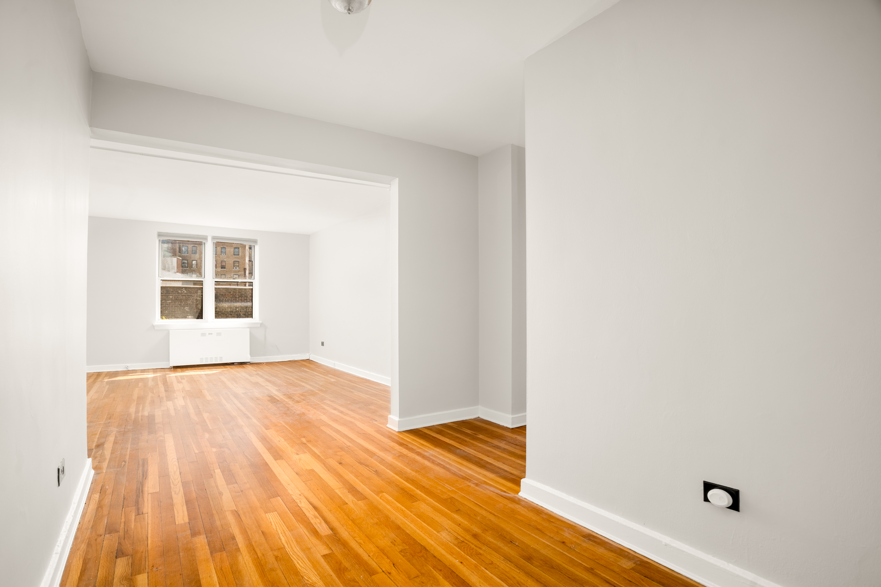 143 Bennett Avenue, Unit 6R Manhattan, NY 10040 - Photo 2 of 22 a view of an empty room and wooden floor