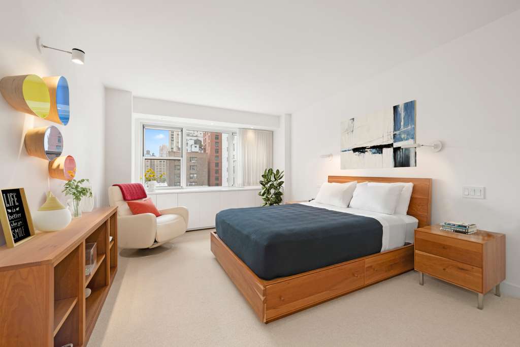 150 East 69th Street, Unit 7K Manhattan, NY 10021 - Photo 20 of 22 a bedroom with a bed and window
