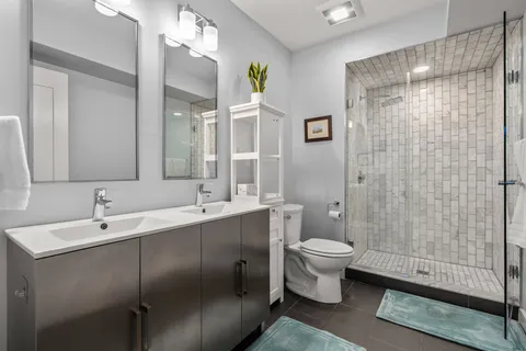 a bathroom with a sink toilet and shower