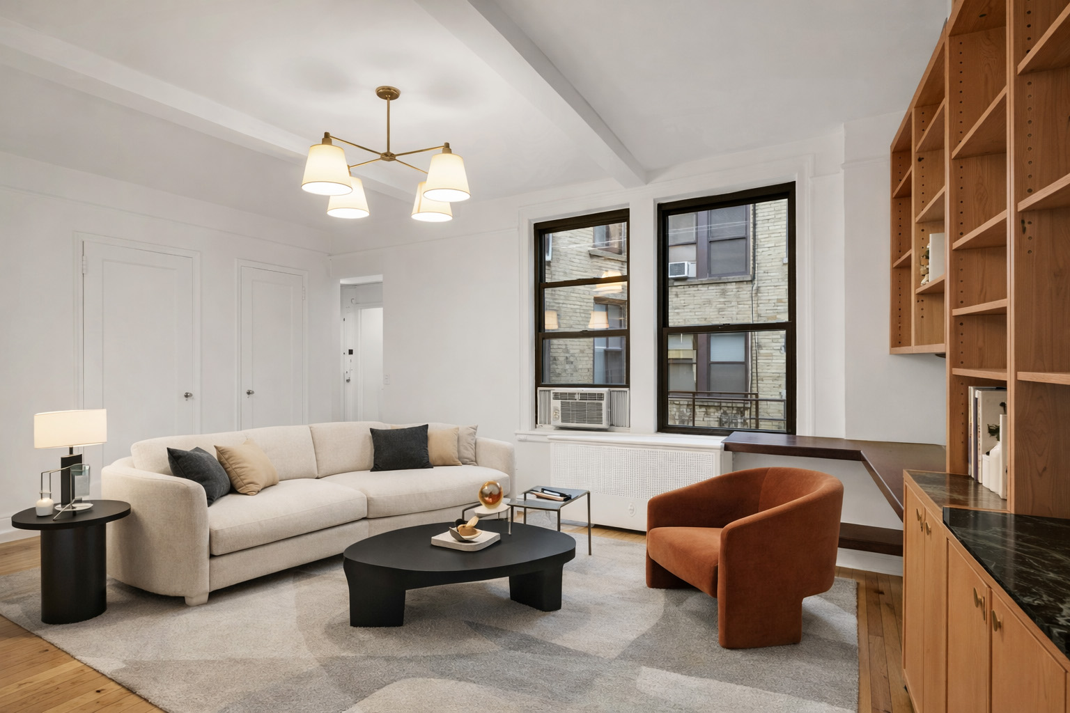 a living room with furniture a chandelier and a window