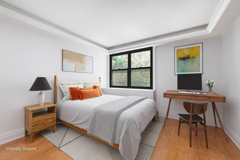 a bedroom with a bed and a desk