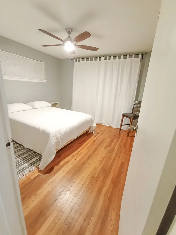 a bedroom with a bed and a window