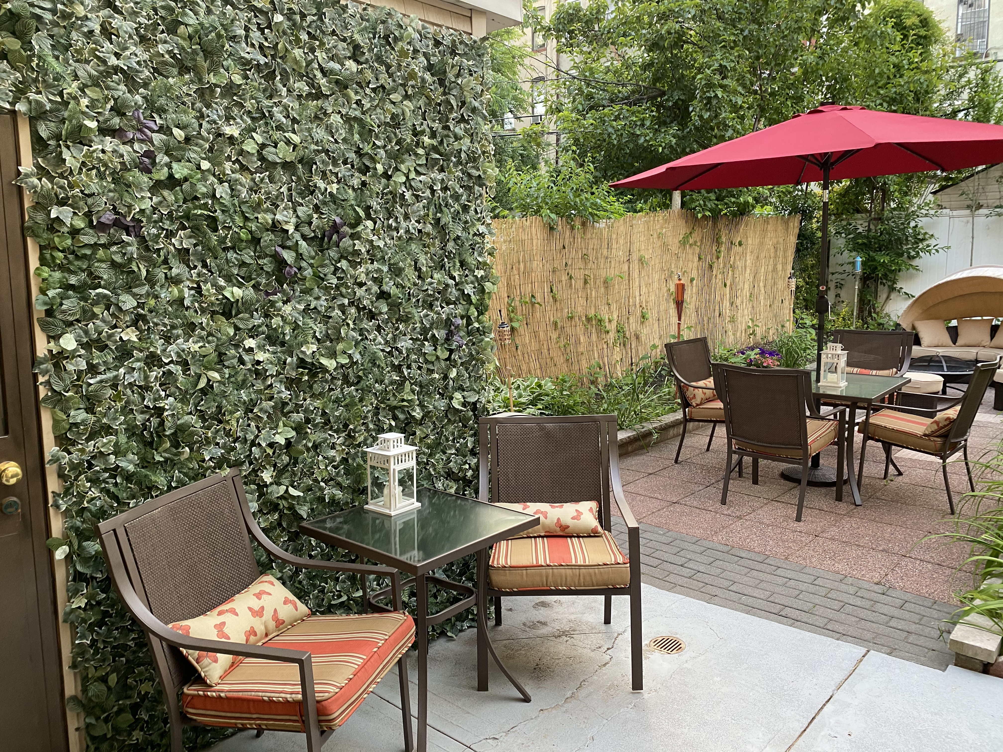 493 Decatur Street, Unit 1 Brooklyn, NY 11233 - Photo 22 of 26 an outdoor sitting area with furniture and umbrella