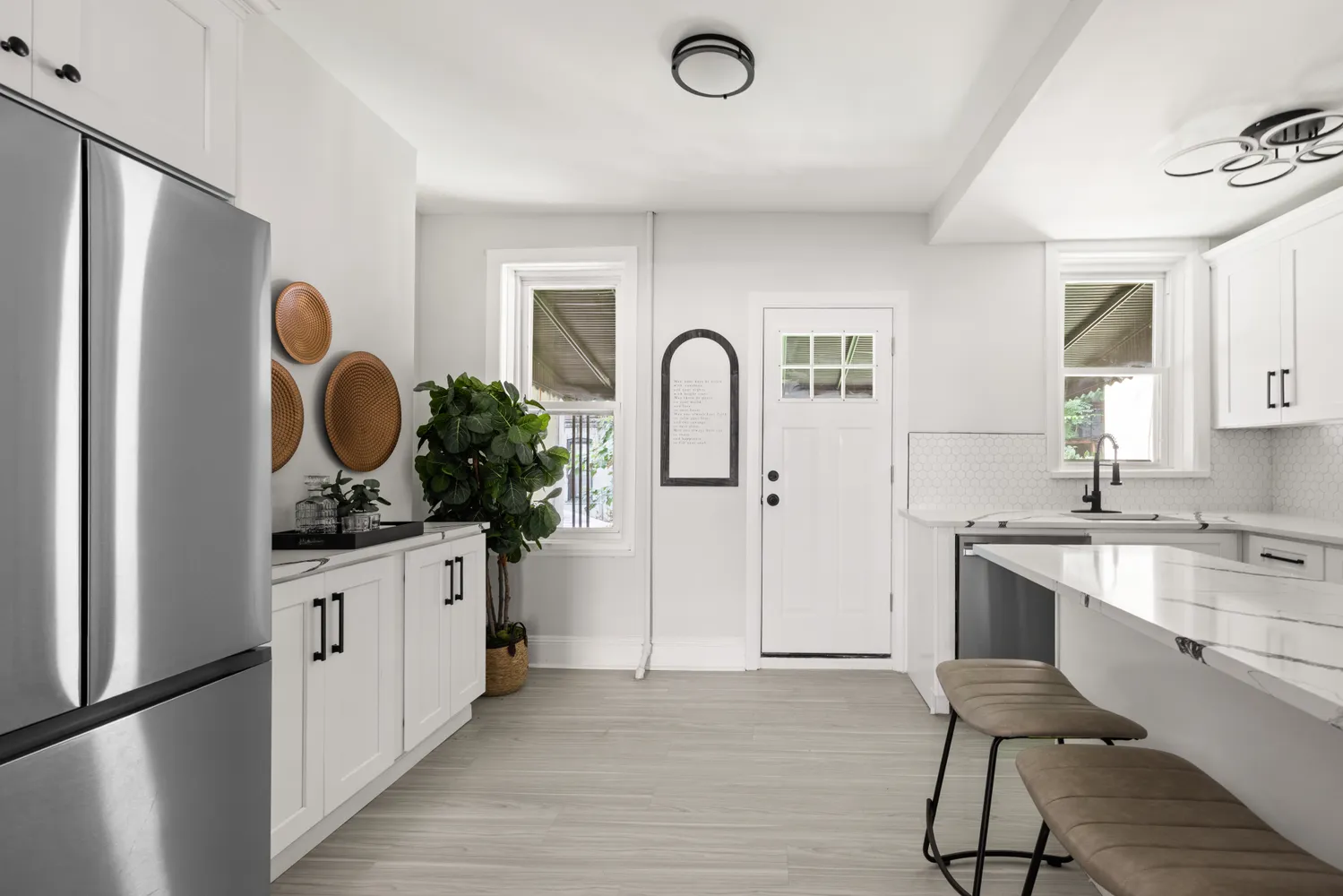 a kitchen with white cabinets and sink