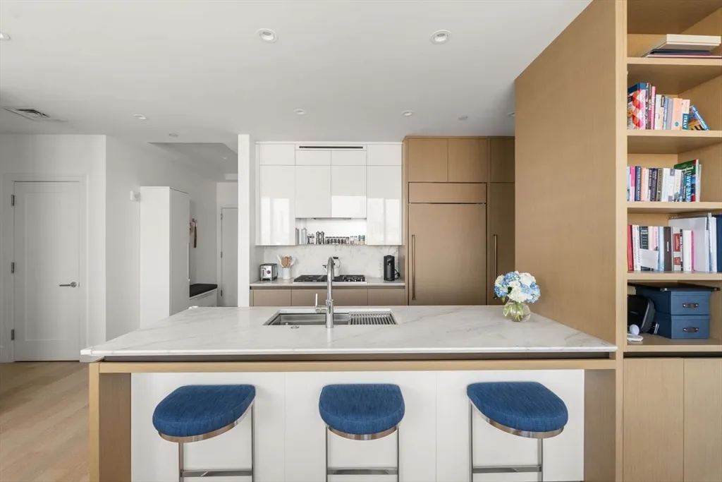 a kitchen with stainless steel appliances granite countertop a sink and a refrigerator