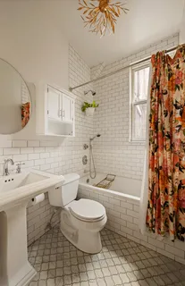 a bathroom with a toilet sink shower and mirror