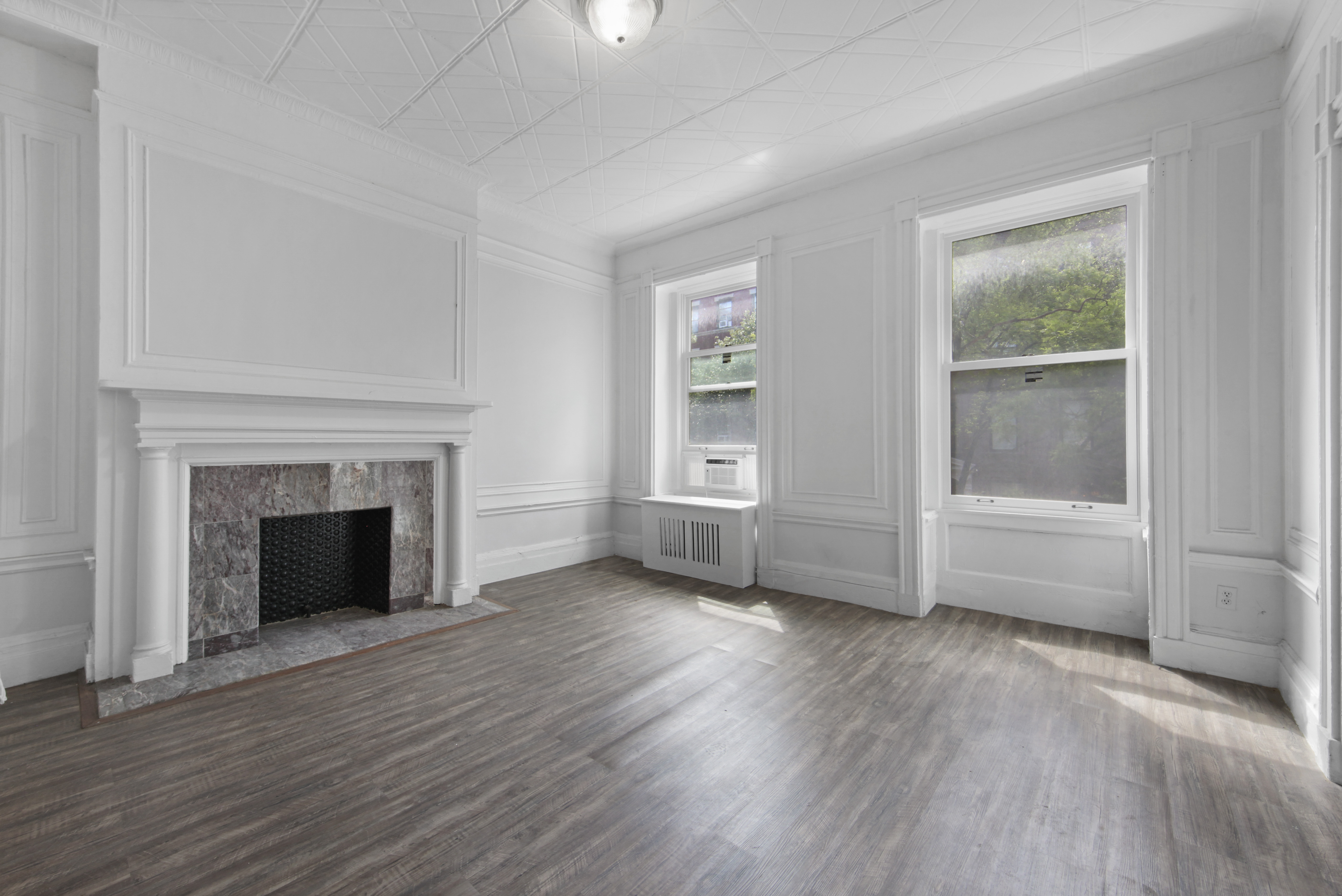 155 Hicks Street, Unit 3A Brooklyn, NY 11201 - Photo 1 of 14 an empty room with wooden floor fireplace and windows