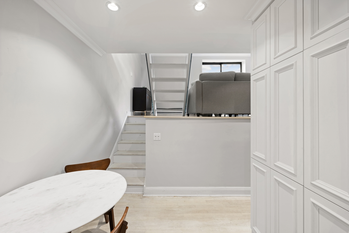 160 East 26th Street, Unit 6B Manhattan, NY 10010 - Photo 4 of 10 a bathroom with a sink a toilet and mirror