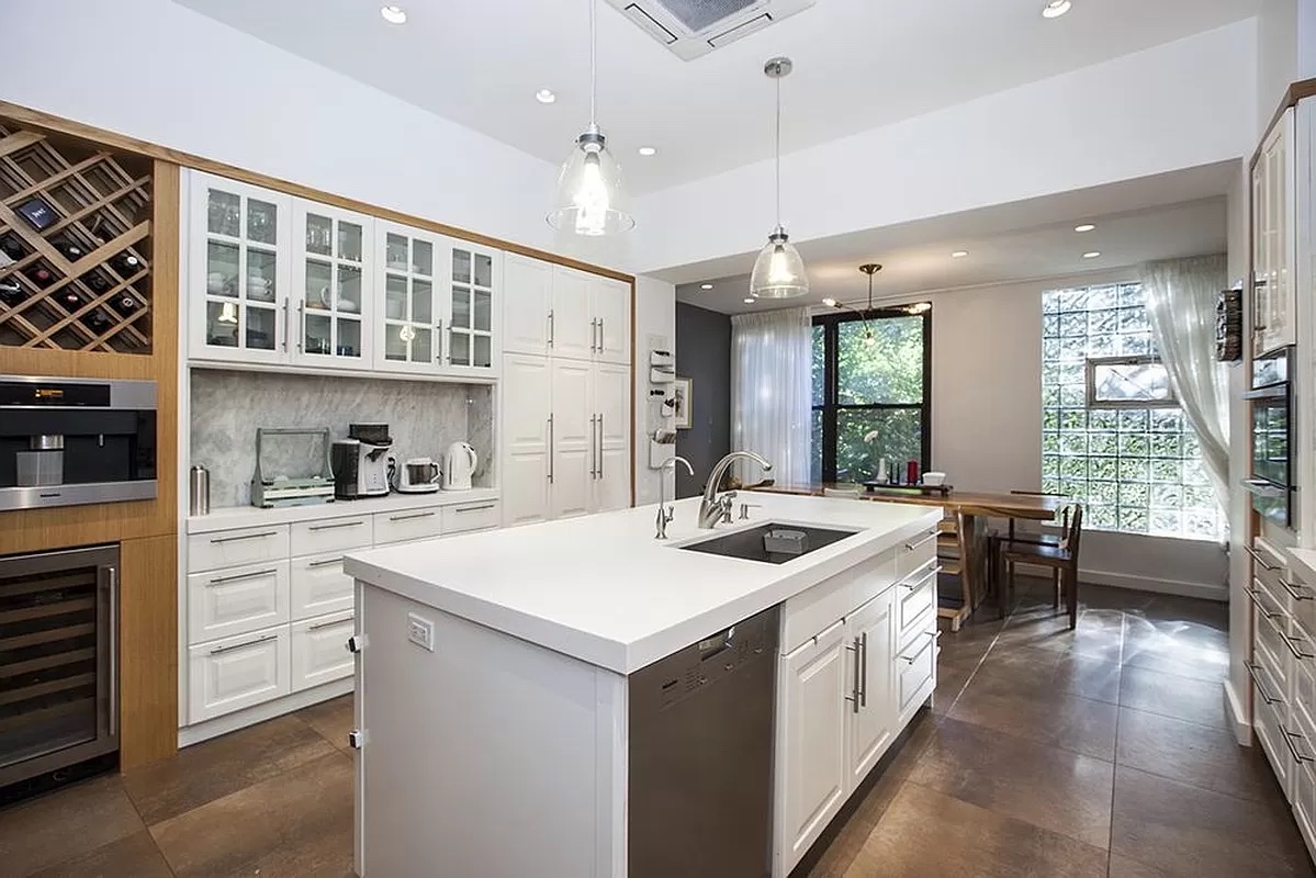 458 West 153 Street Manhattan, NY 10031 - Photo 2 of 16 a kitchen with a sink stove and cabinets