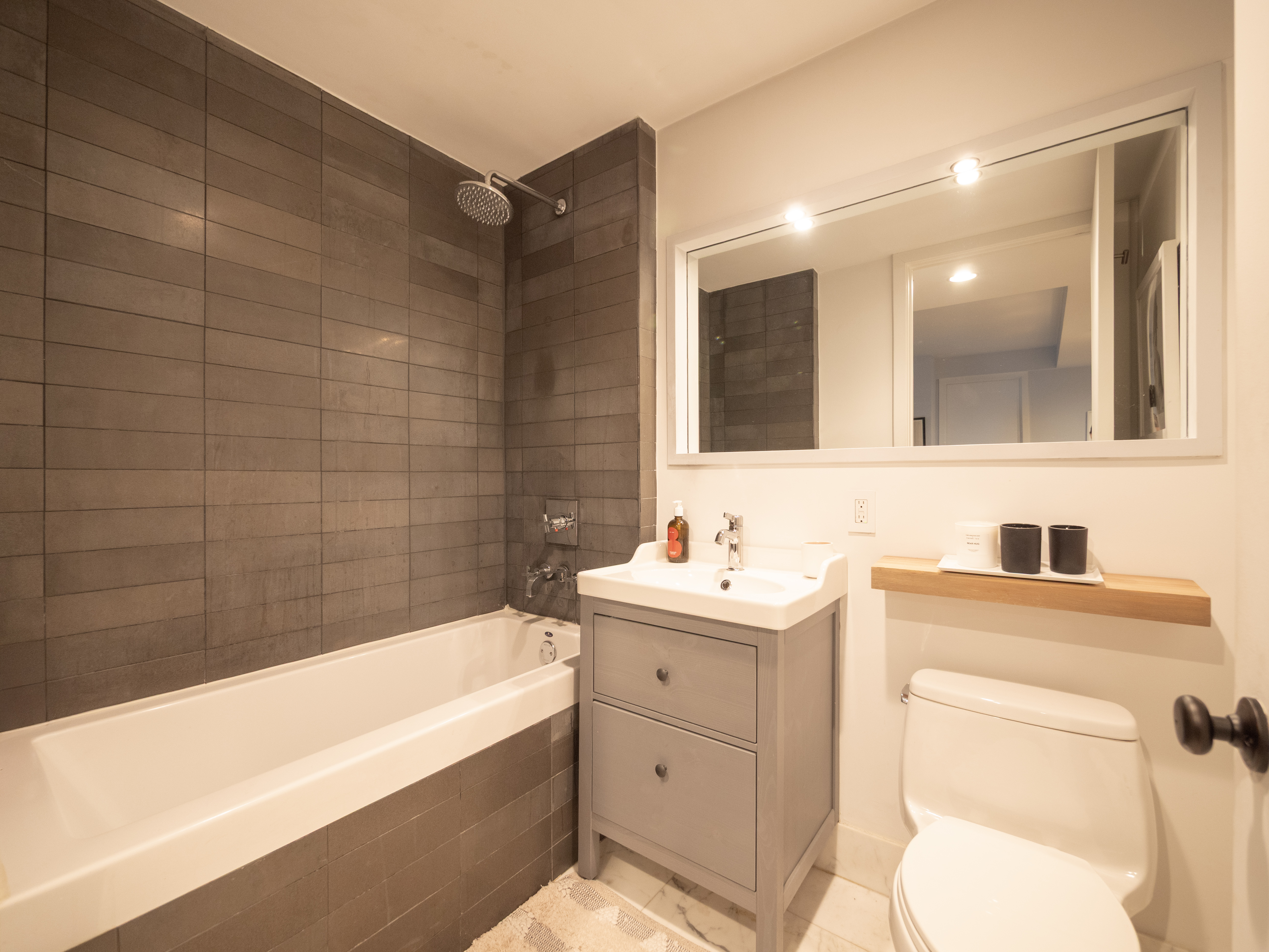 84 Front Street, Unit 5E Brooklyn, NY 11201 - Photo 10 of 11 a bathroom with a sink a toilet and bathtub