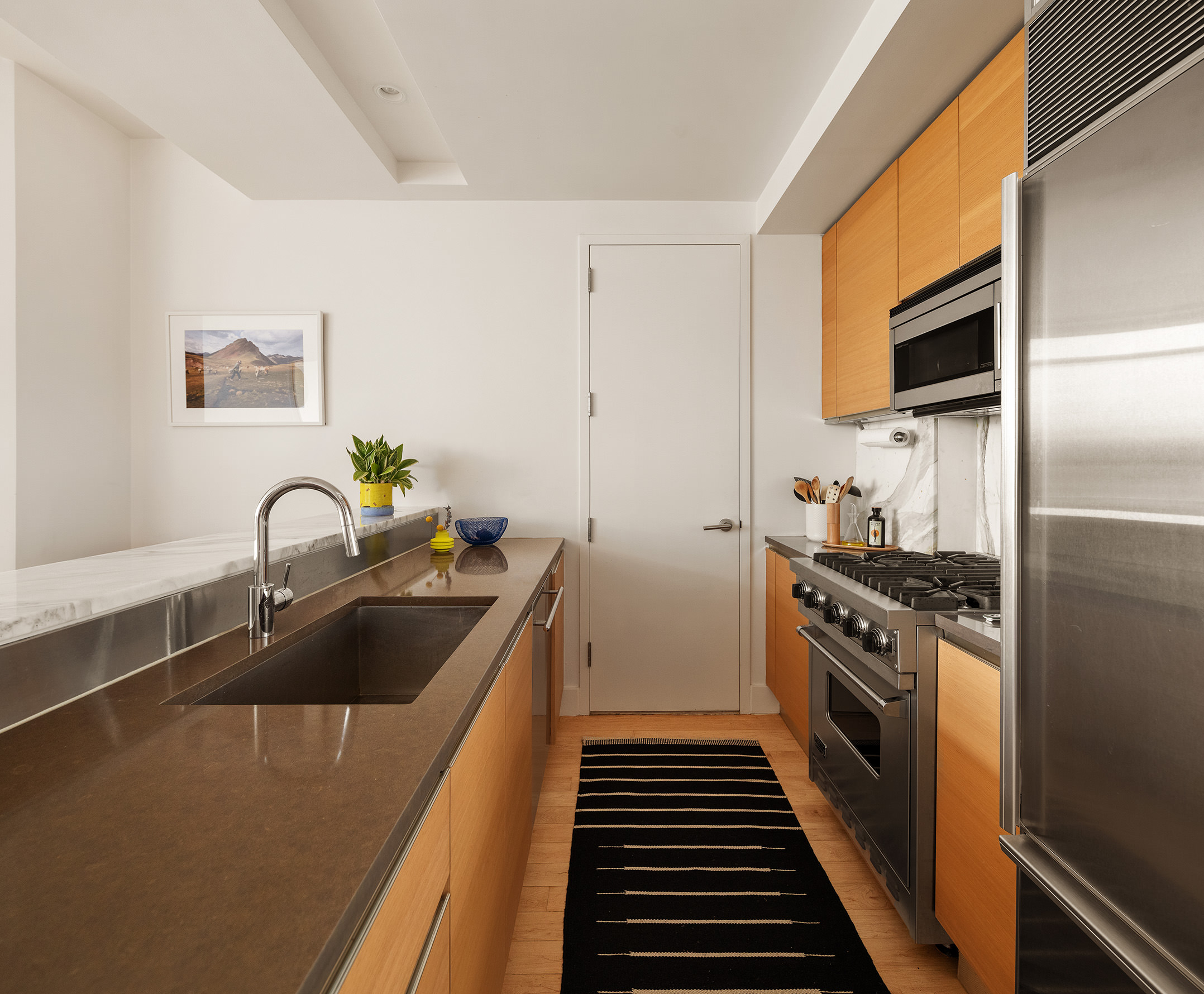 20 Bayard Street, Unit 6C Brooklyn, NY 11211 - Photo 3 of 10 a kitchen with granite countertop a stove and a sink