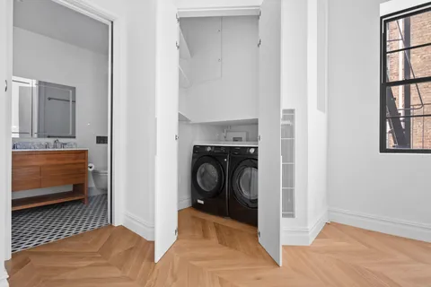 a view of a livingroom with furniture and staircase