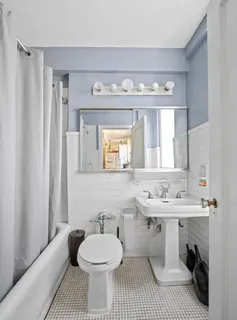 a bathroom with a sink a toilet and mirror