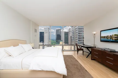 a kitchen with a sink a refrigerator and a stove top oven