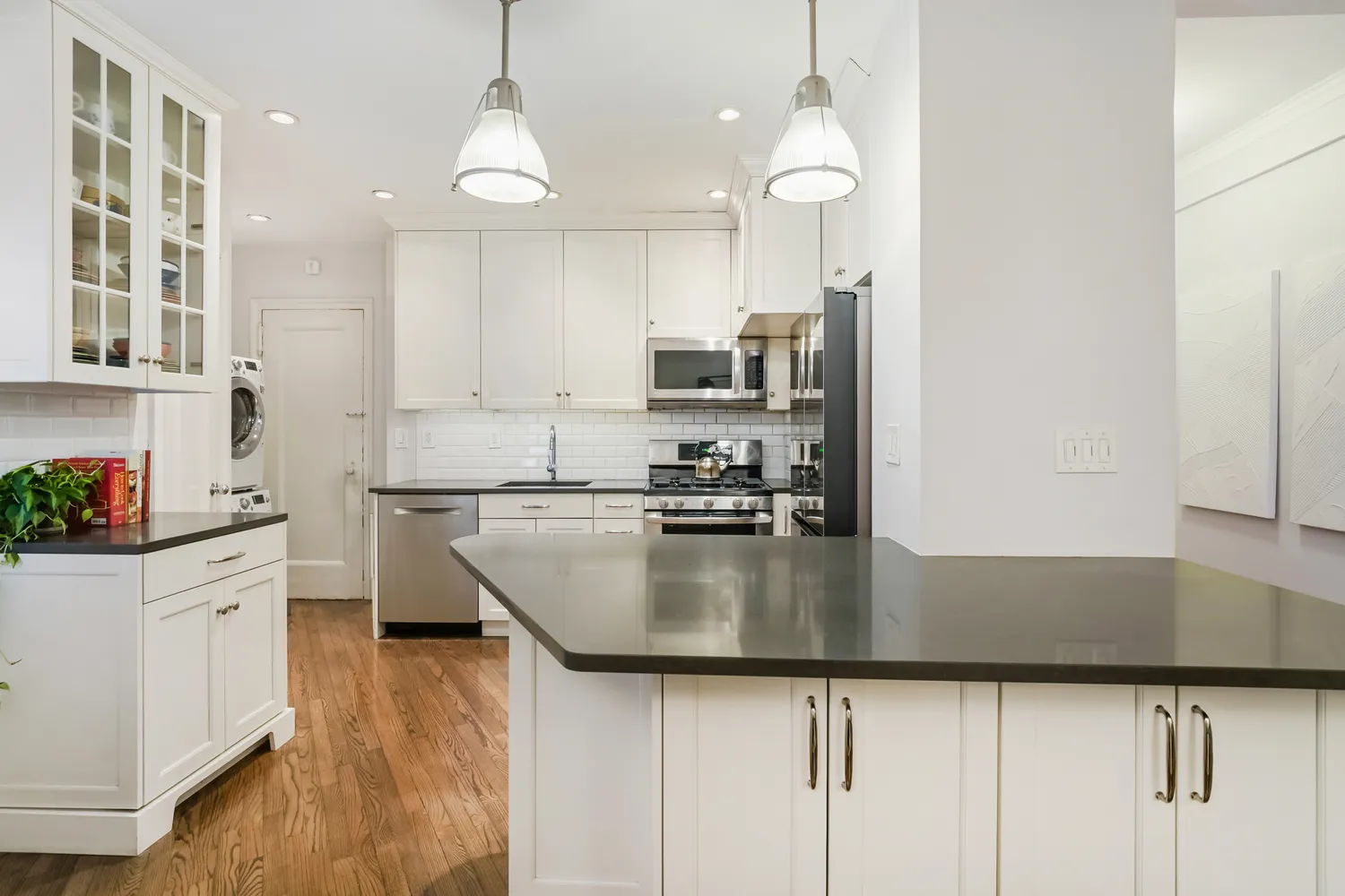 a kitchen with kitchen island a counter top space appliances and cabinets