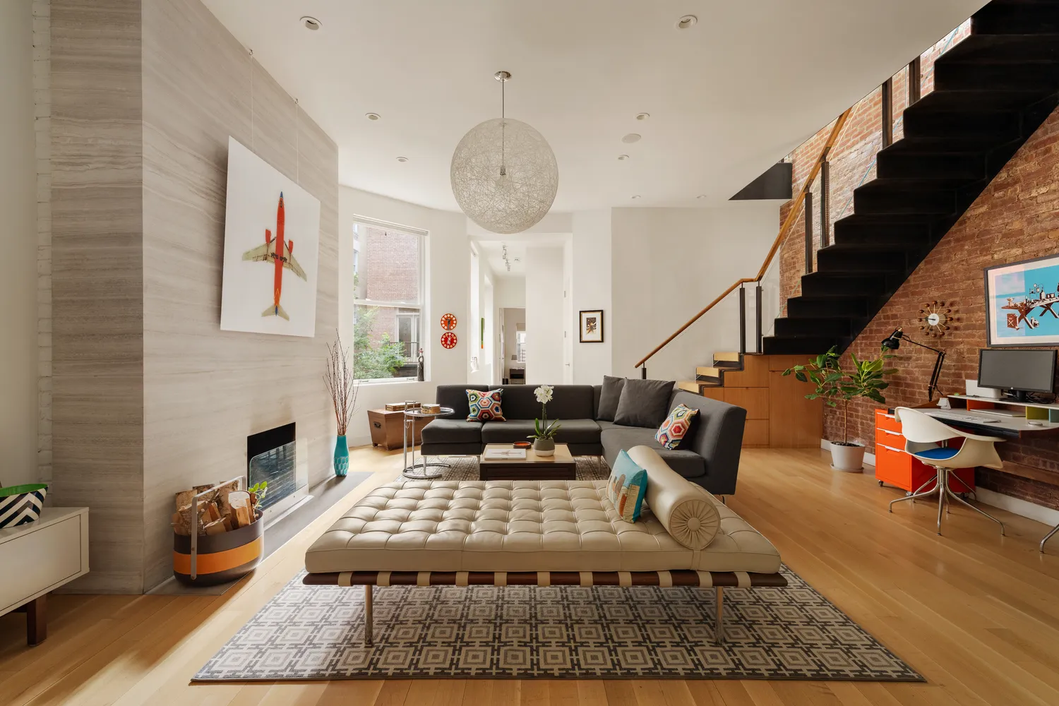 a living room with furniture rug and a fireplace