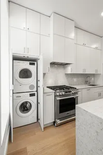 an empty room with closet and wooden floor