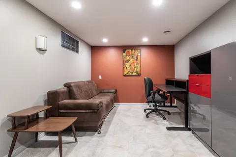 a livingroom with workspace and a couch