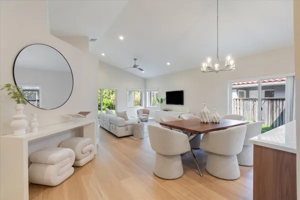 a living room with furniture a flat screen tv and a large window