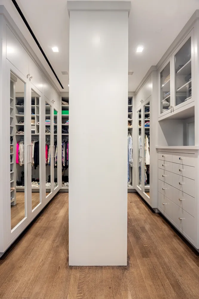 a view of walk in closet with clothes and shoes