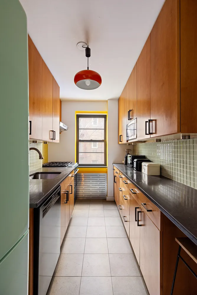 a kitchen with stainless steel appliances granite countertop a sink and a stove