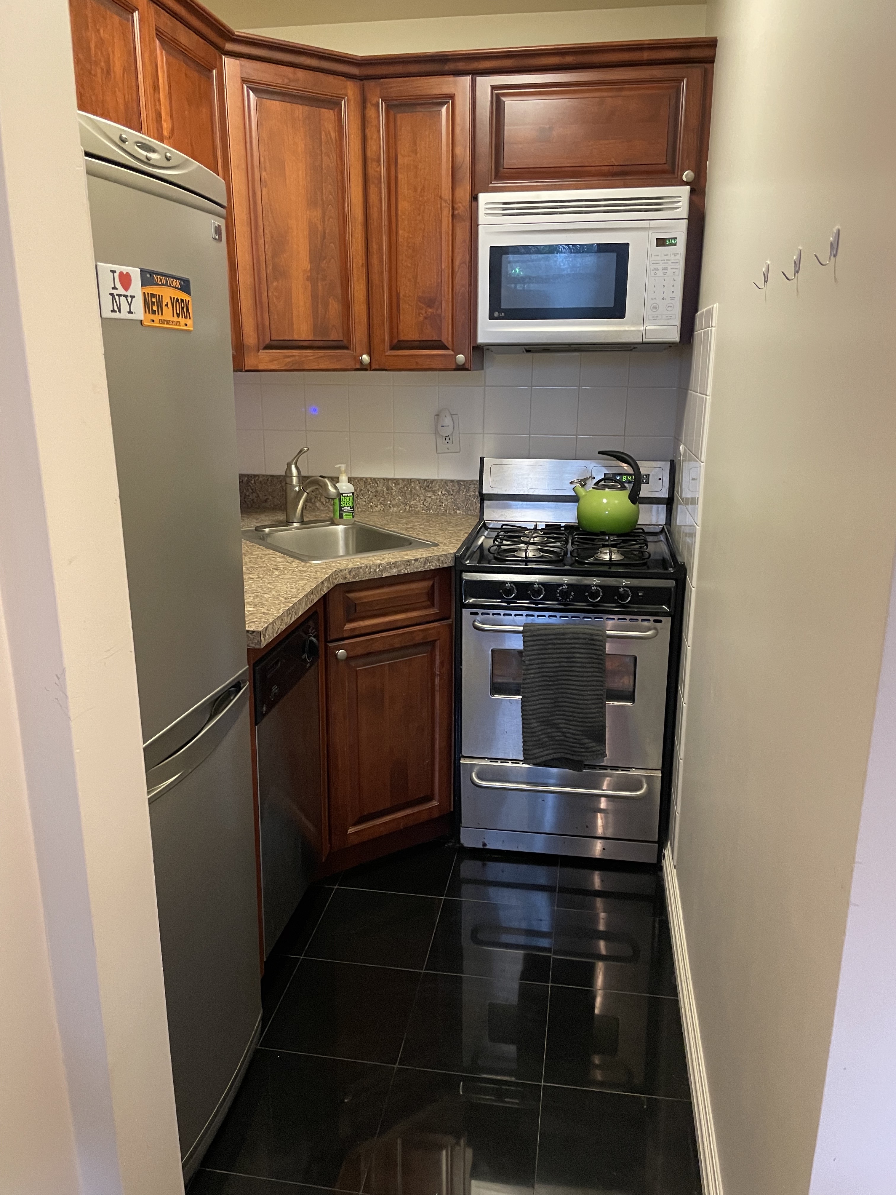 91 Hanson Place, Unit 2A Brooklyn, NY 11217 - Photo 3 of 4 a kitchen with stainless steel appliances a stove a microwave and a sink